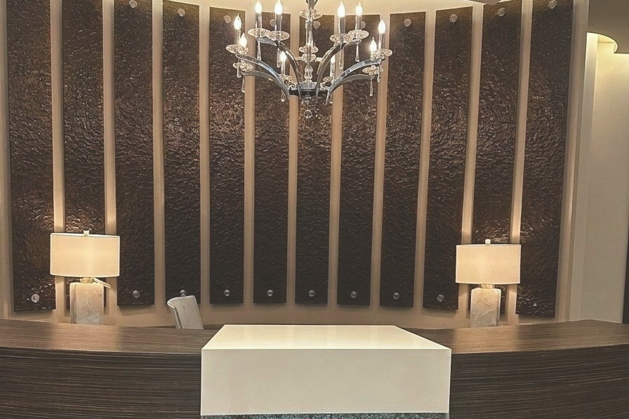 Reception area at Improve Canada Centre with a curved desk and chandelier